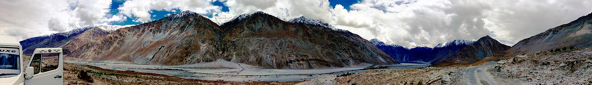 A vast landscape of mountain ranges surrounding the Leh valley.