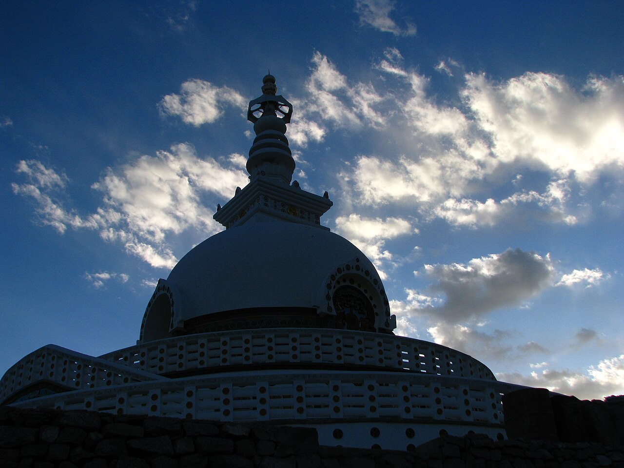 White dome of Shanti Stupa overlooking Leh at sunset