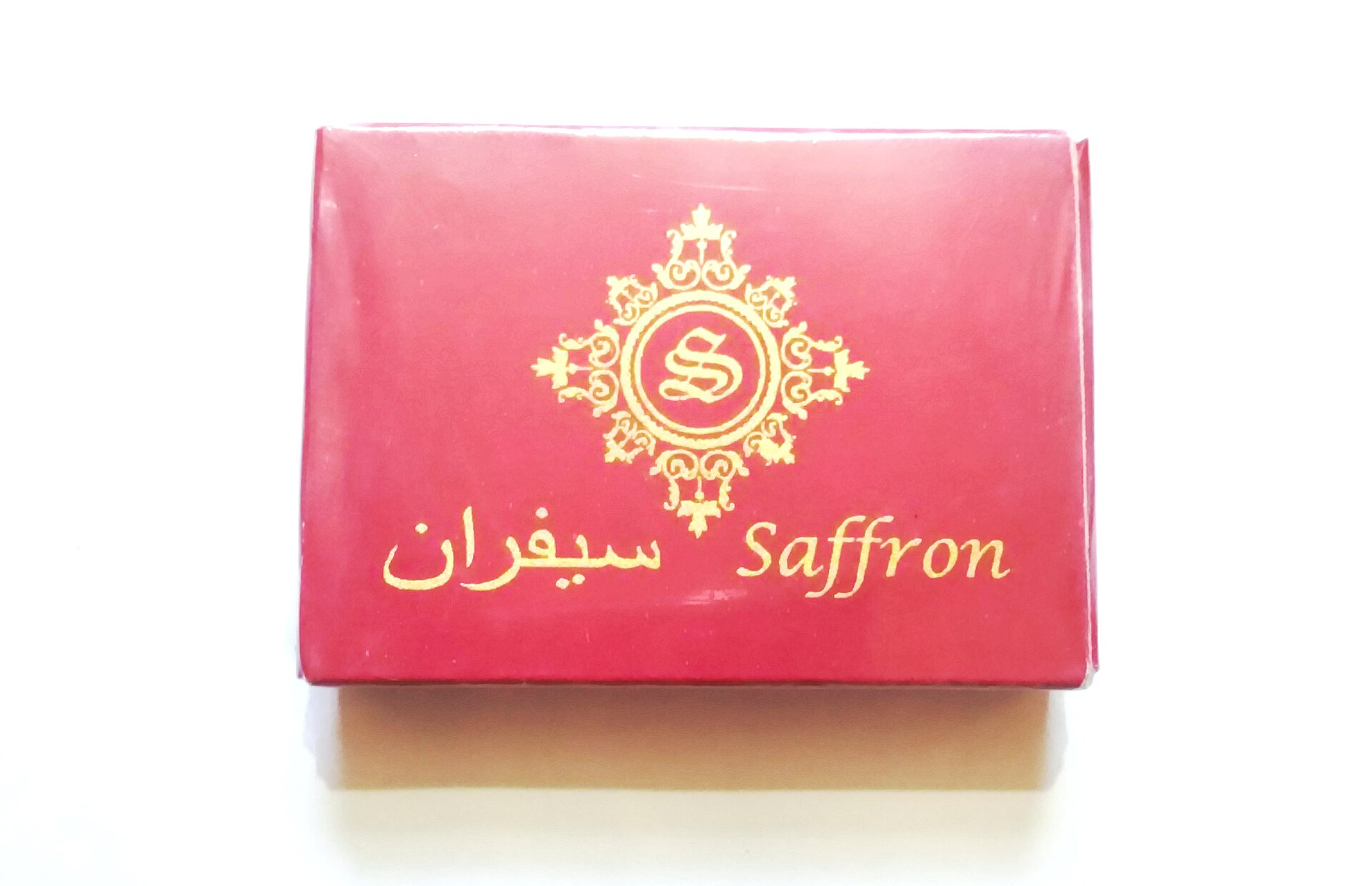 High quality red saffron threads in a glass container
