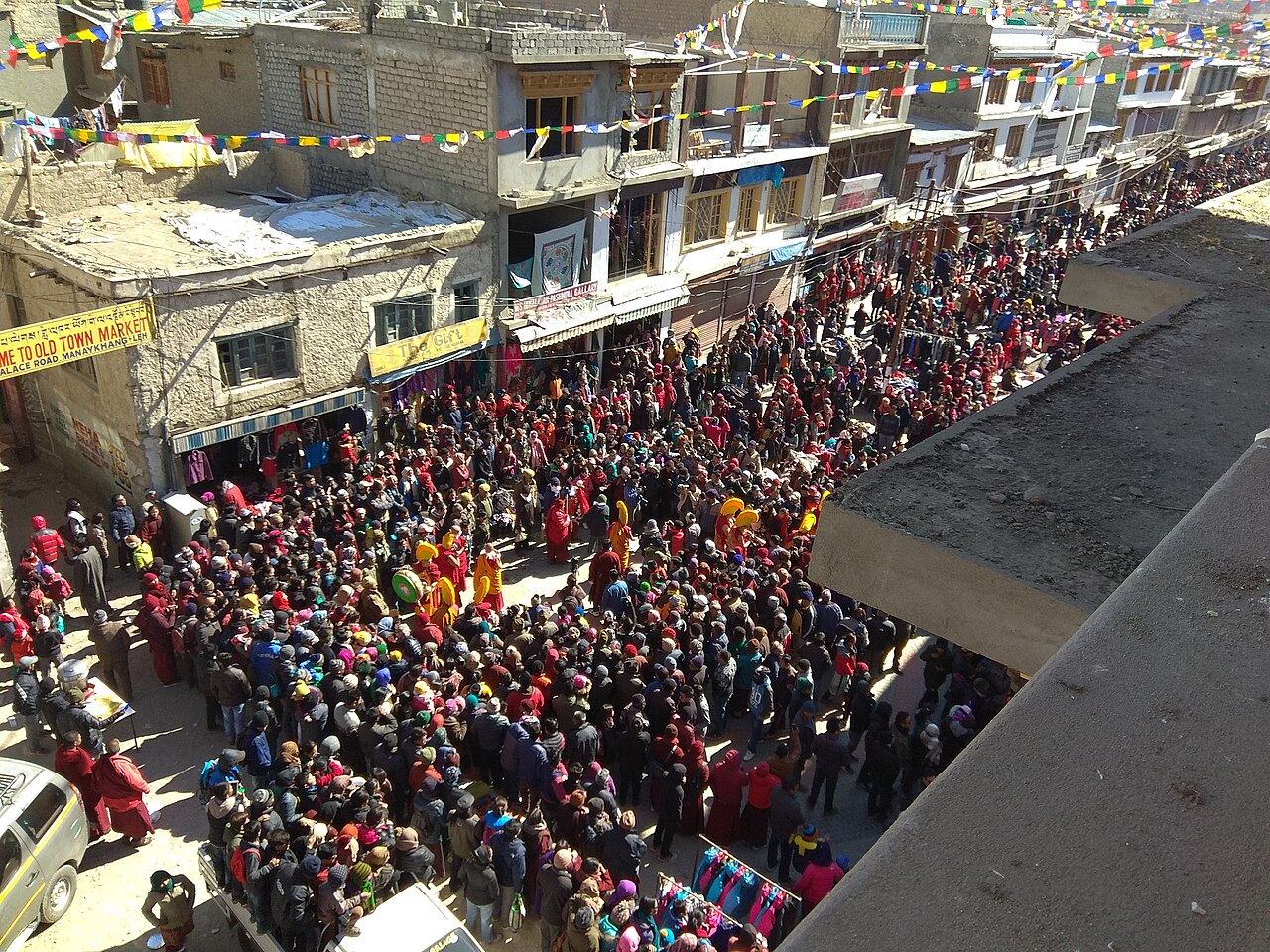 Busy market street in Leh with traditional buildings