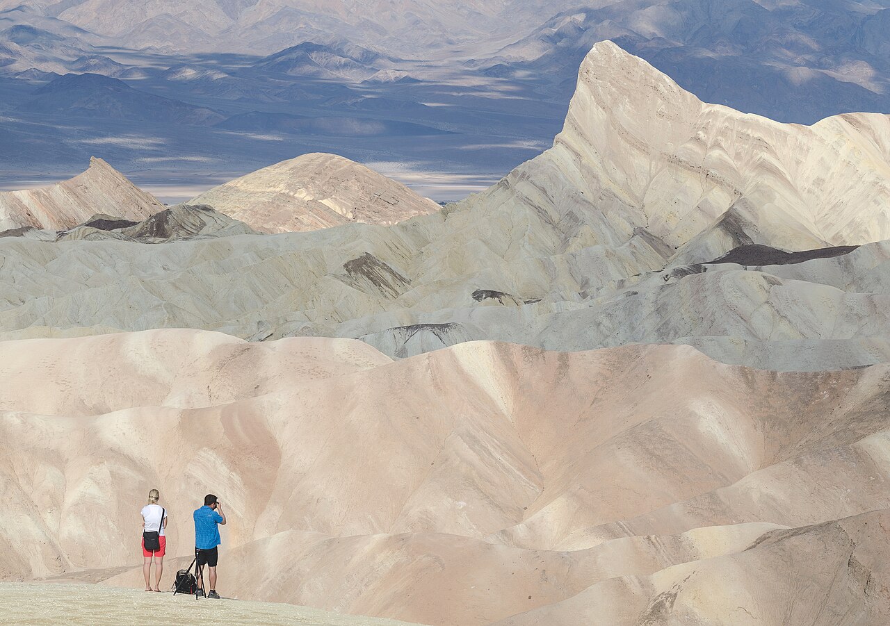 Hikers walking on a mountain trail in Aru