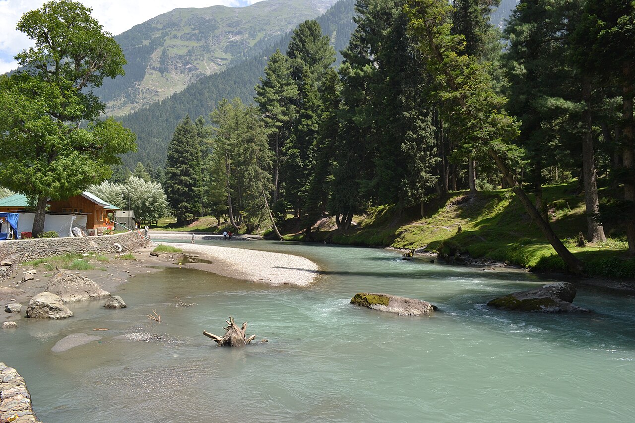 People enjoying the Lidder river banks in summer