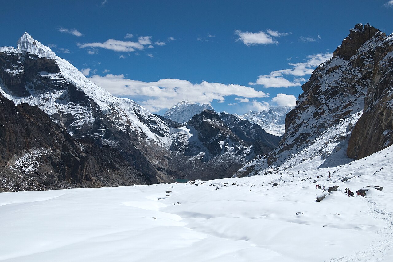 Thick clouds rolling over a mountain ridge at a high pass