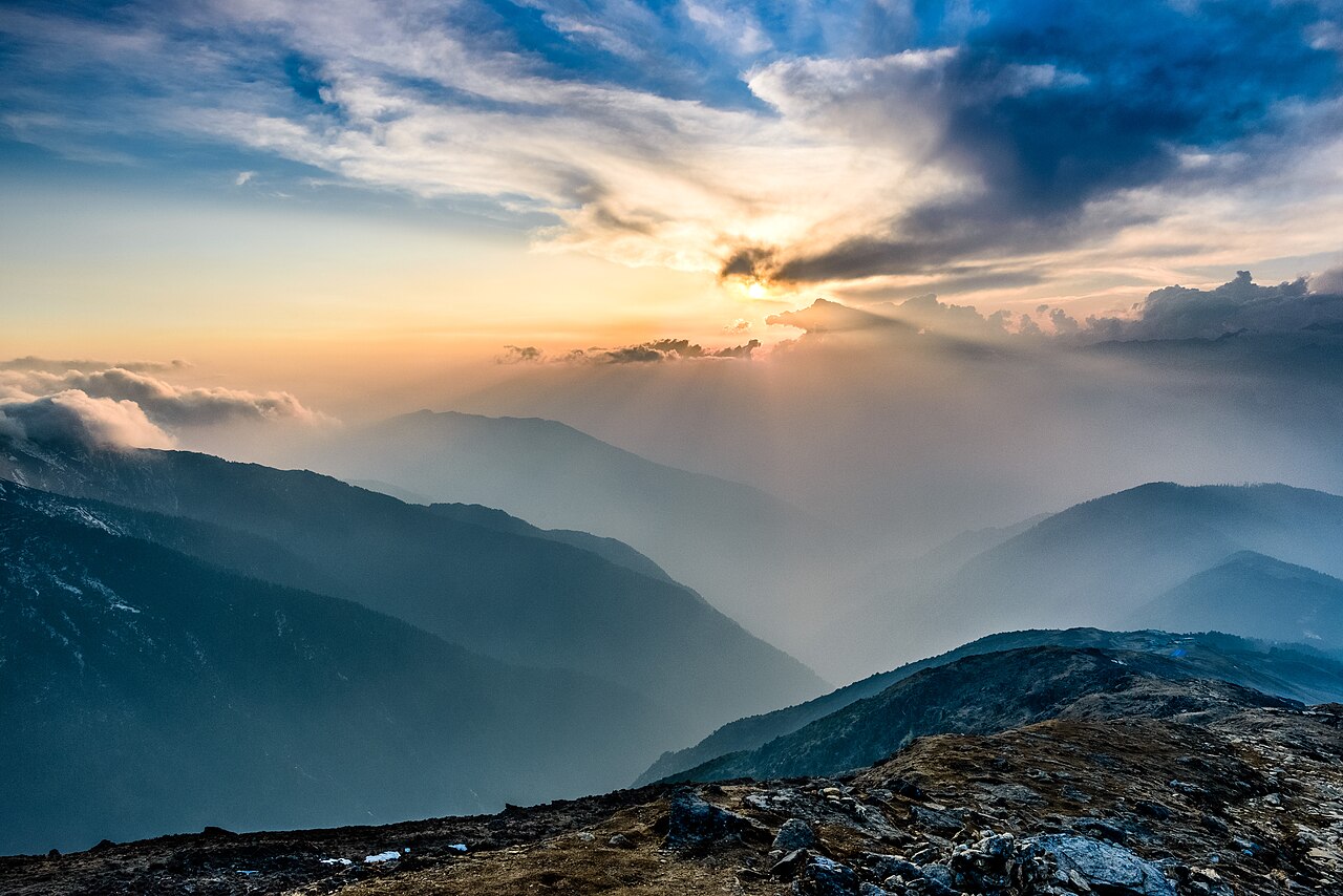 Serene sunset casting golden light over mountain ridges in Jammu