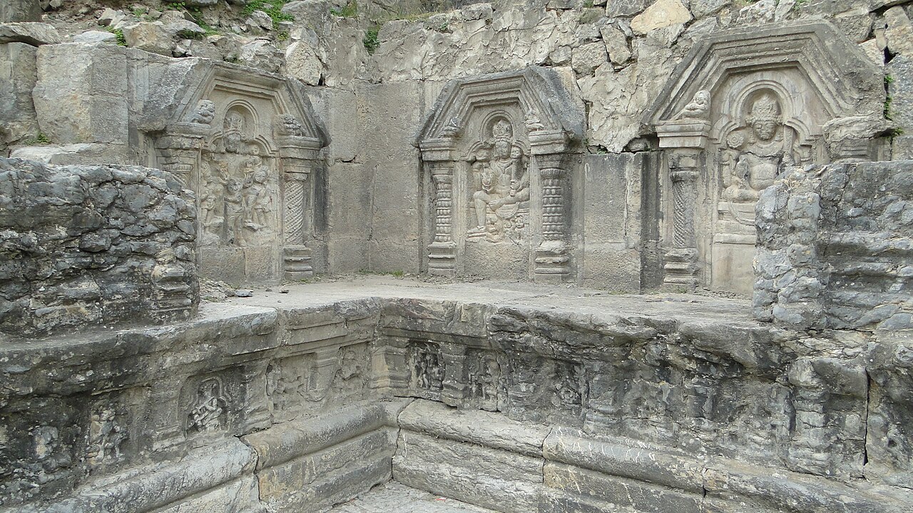 Traditional stone temple courtyard overlooking mountain ridges