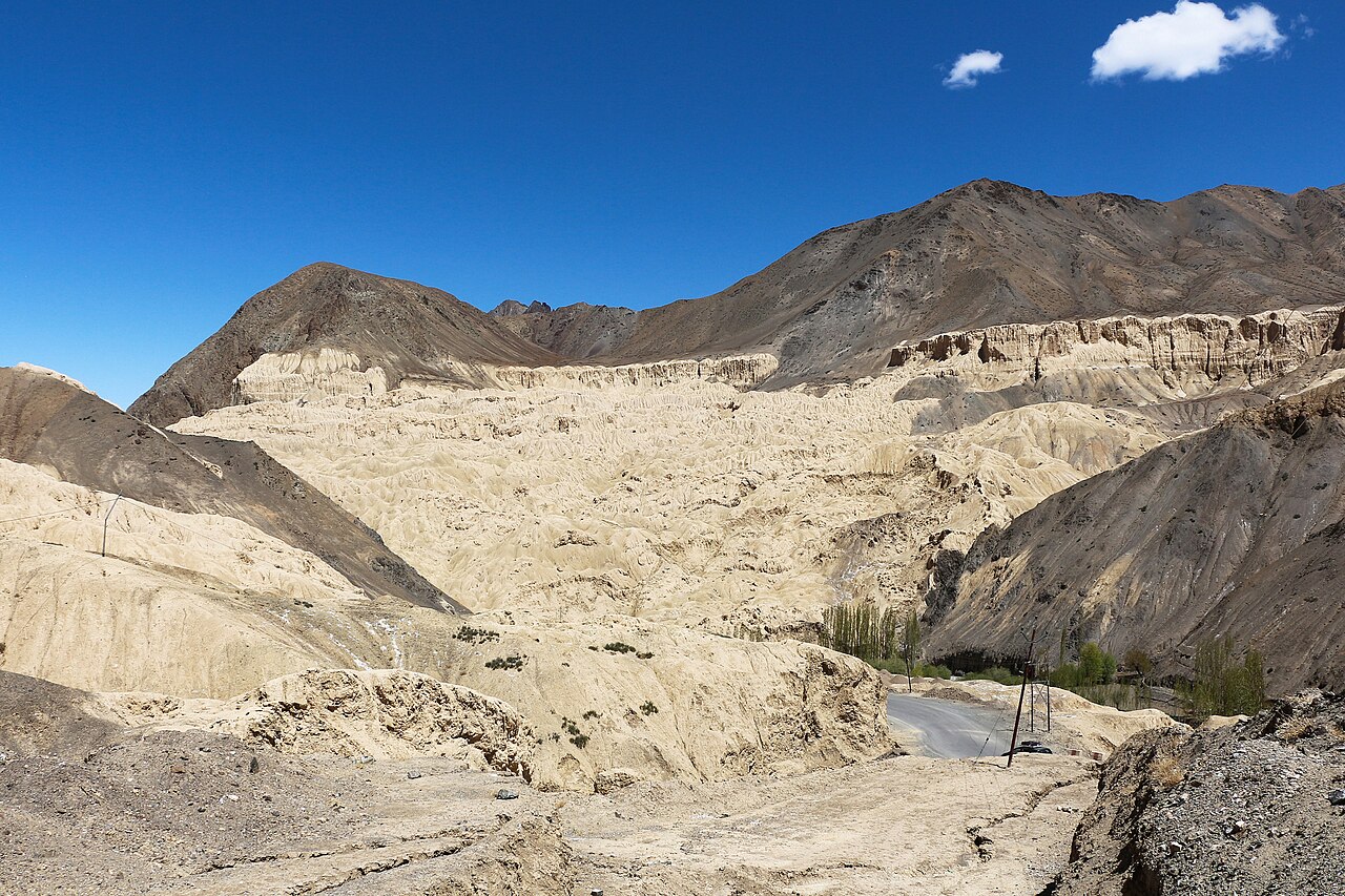 An SUV driving on a high-altitude road.
