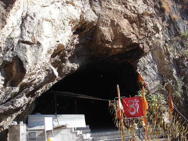 Devotees walking along the paved mountain path towards Shiv Khori cave
