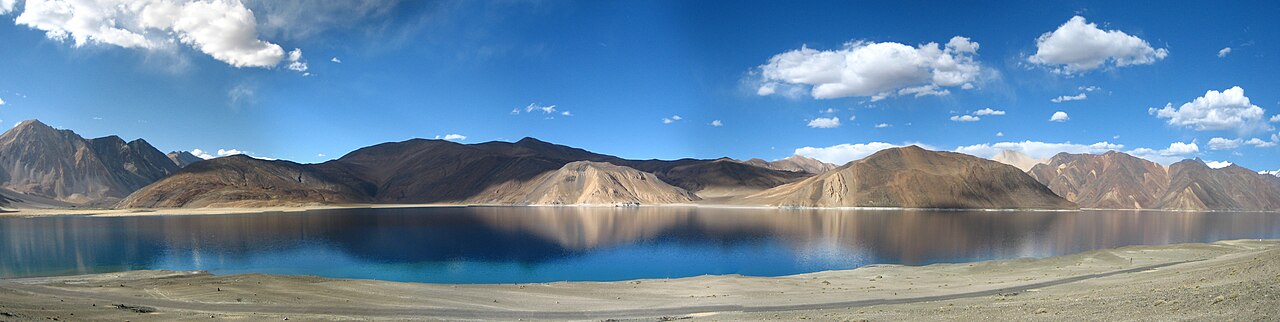 Sunset light hitting the mountains and water of Pangong Tso
