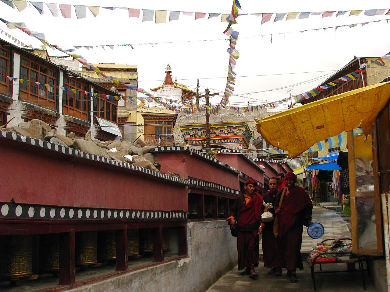 Busy street in Leh market with travel agencies and shops
