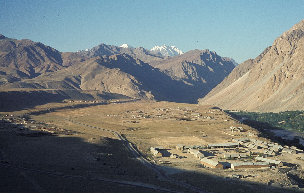 Green river valley with winding stream and trees