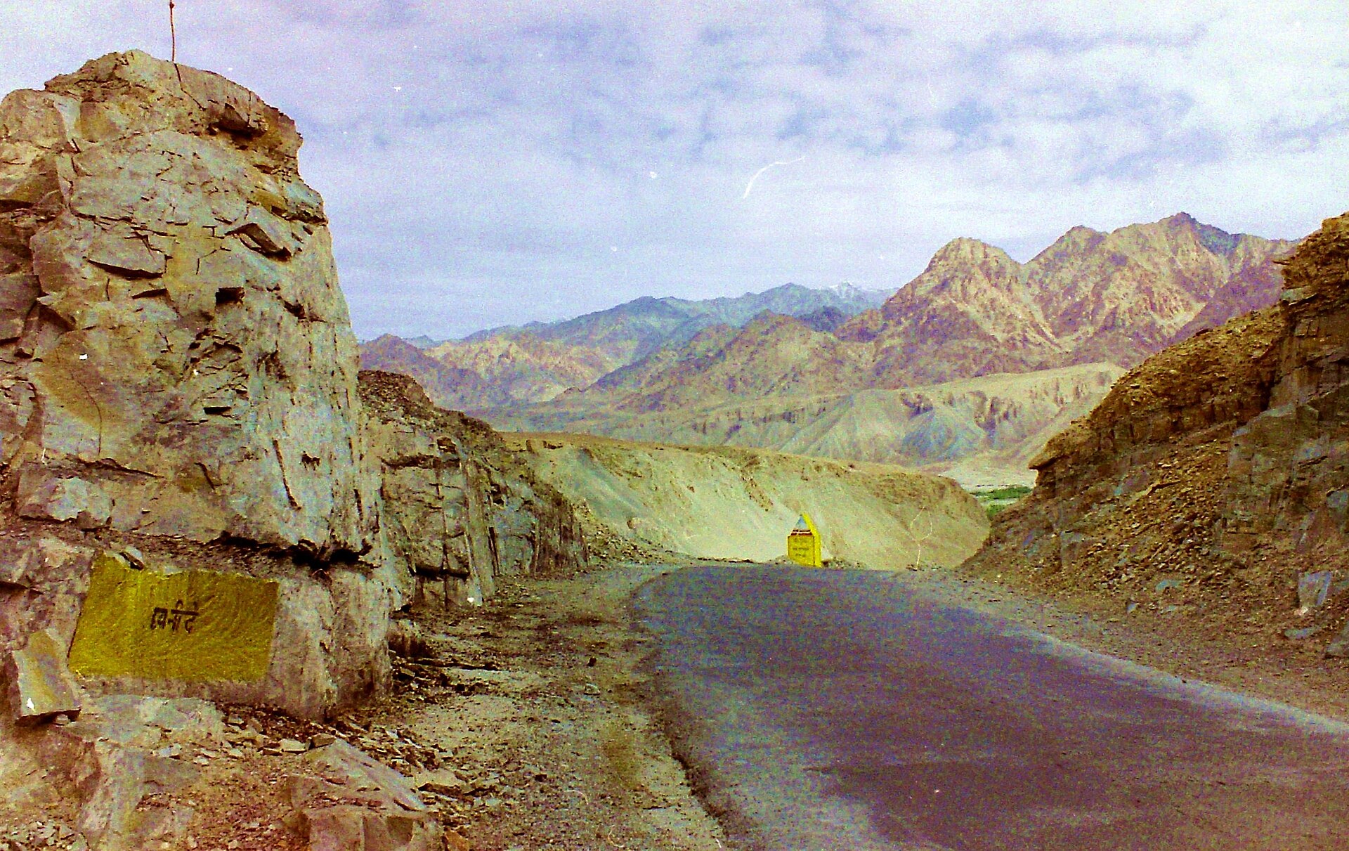 A winding, unpaved mountain road leading into the distance.