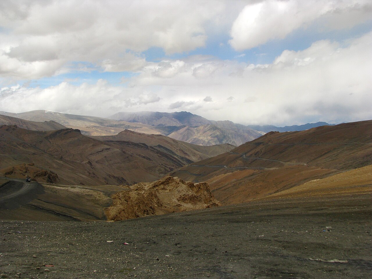 Road workers operating in a mountain environment.