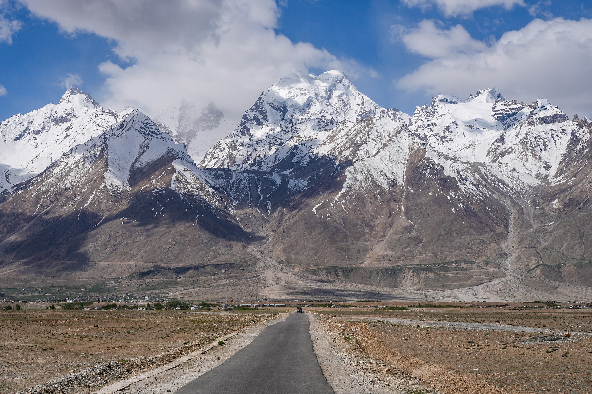 A long, winding mountain road through the dry hills of Ladakh