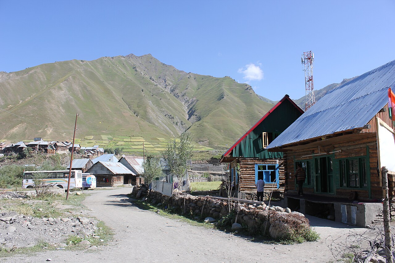 Panoramic view of a mountain valley town surrounded by green hills