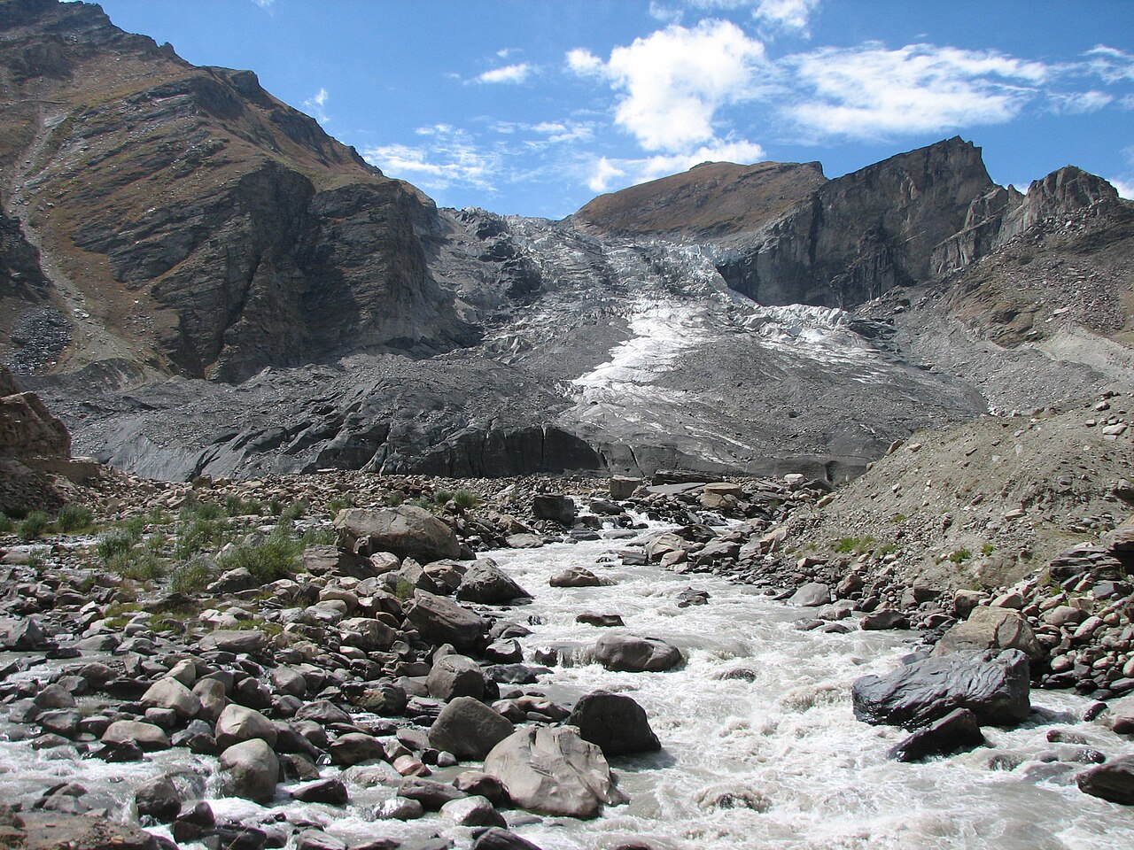 A 4x4 vehicle driving along a mountain road in Ladakh.