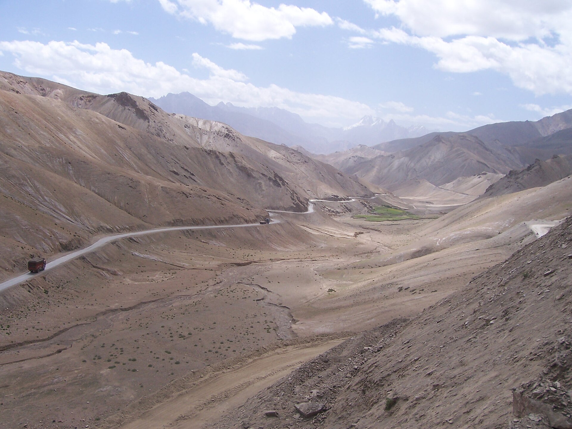 A long, winding mountain road stretching towards the horizon.