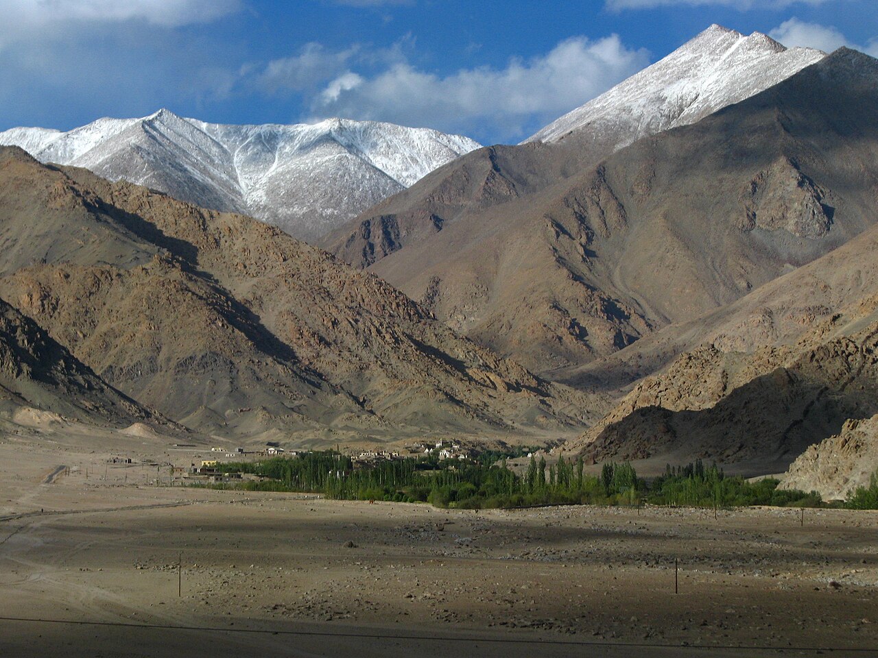 A small, simple tea stall on the side of a mountain road.