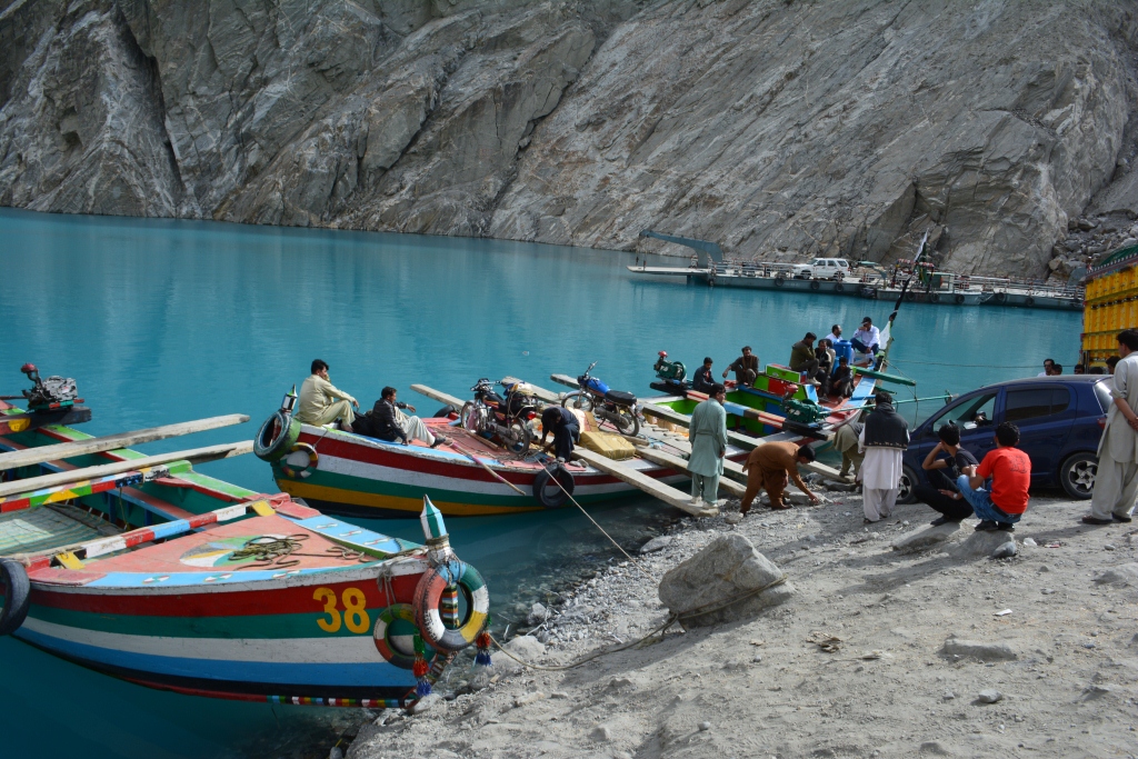A peaceful scene with locals walking near the water.