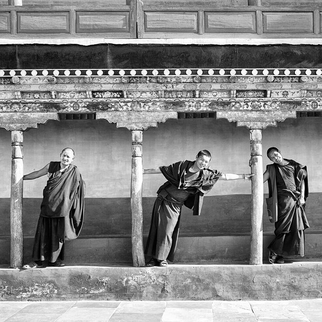 Monks gathered in an assembly hall in Ladakh