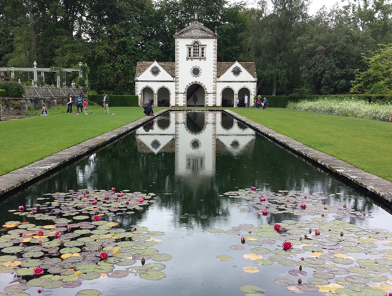 Symmetrical water basins and stone paths across garden terraces