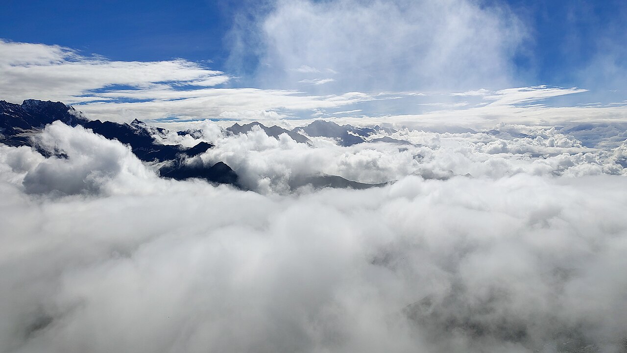 Pilgrims walking along a high altitude mountain ridge during yatra