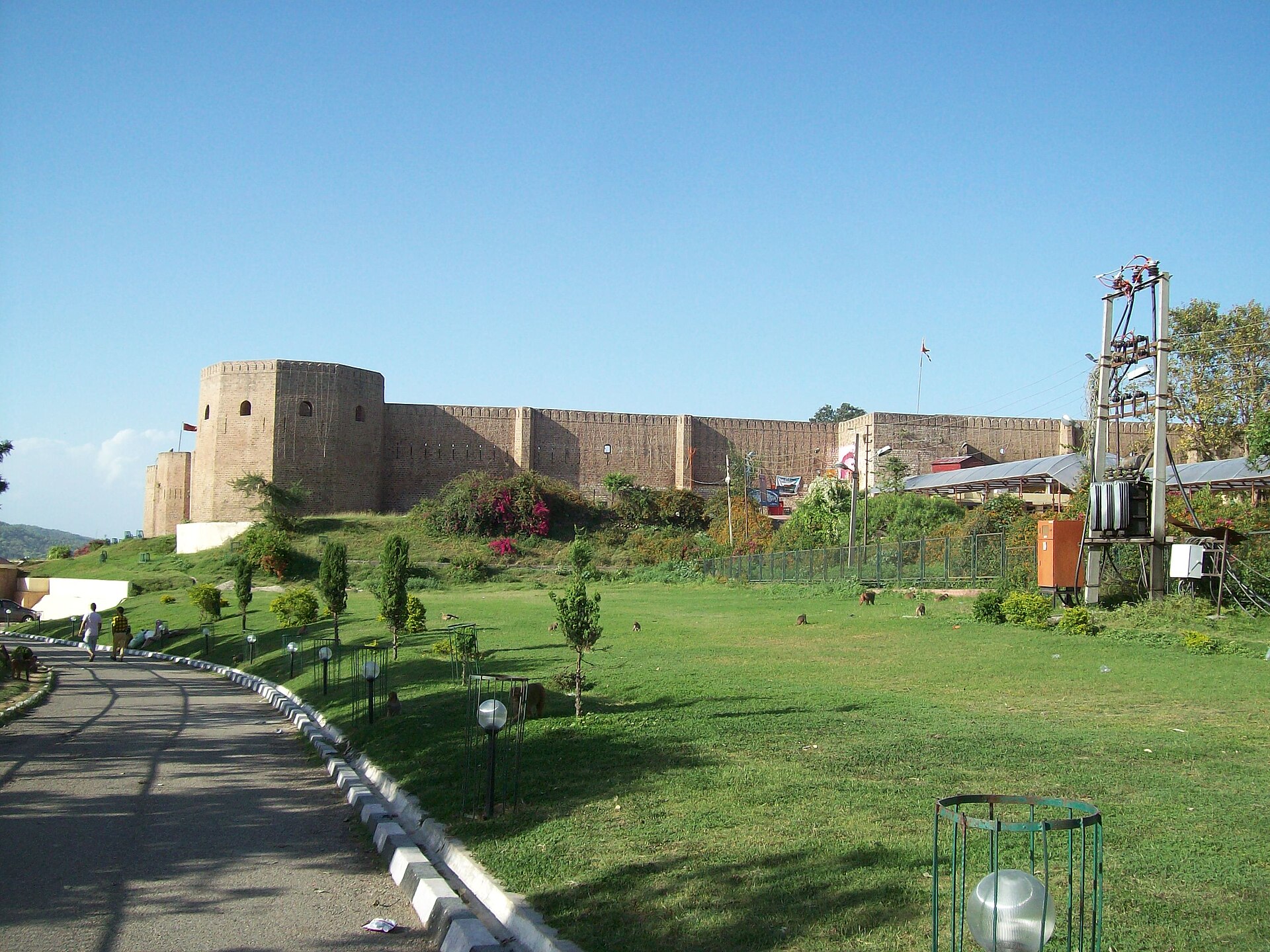 Ancient stone ramparts of Bahu Fort under a clear sky.