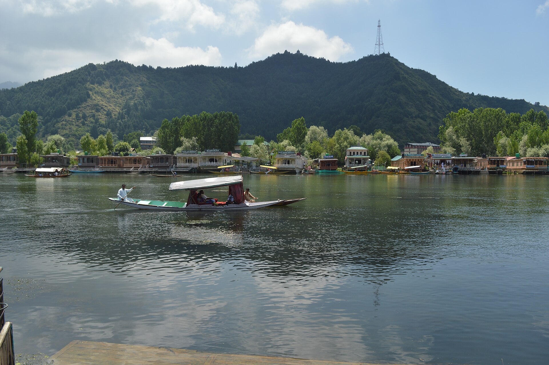 Wooden shikara boat on Nigeen Lake during golden hour