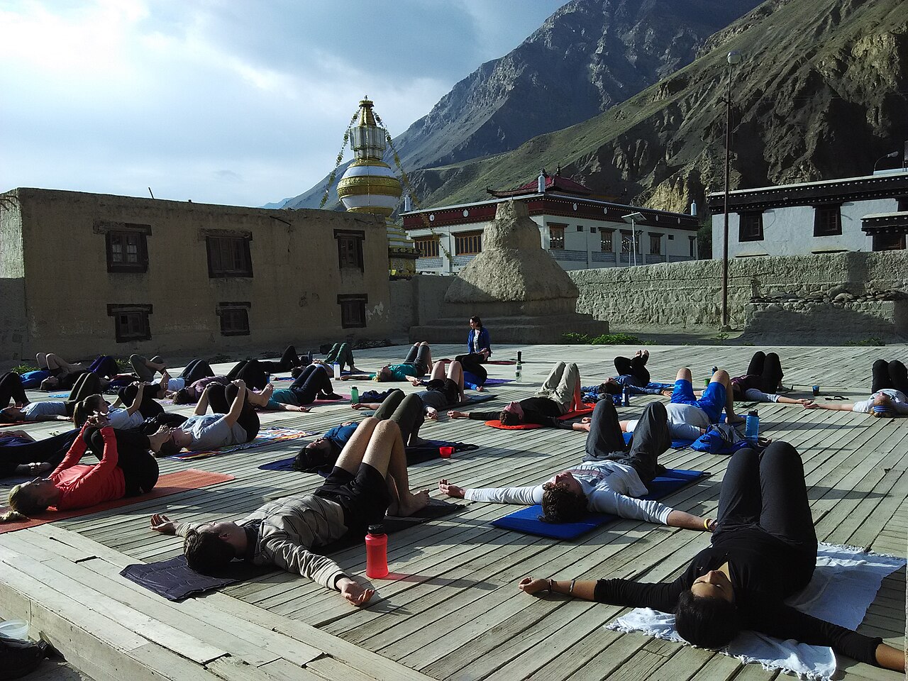 Tourists watching cultural performances from monastery balcony in Ladakh