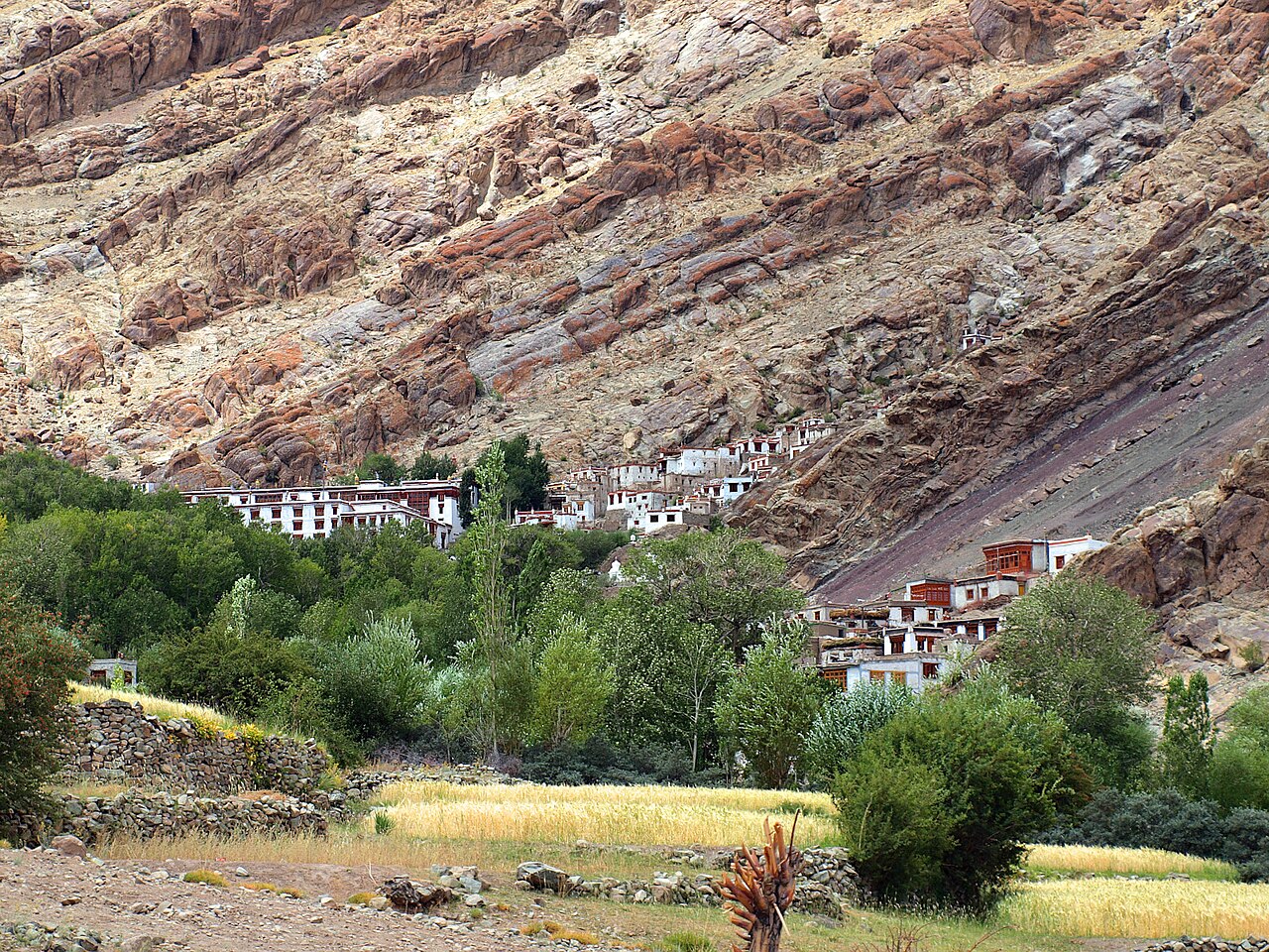 Traveler wearing sun protection in a monastery courtyard in Ladakh