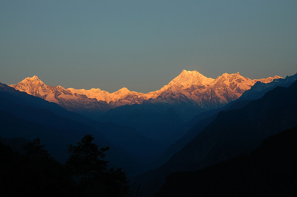 Towering mountain peak with a clear blue sky background.