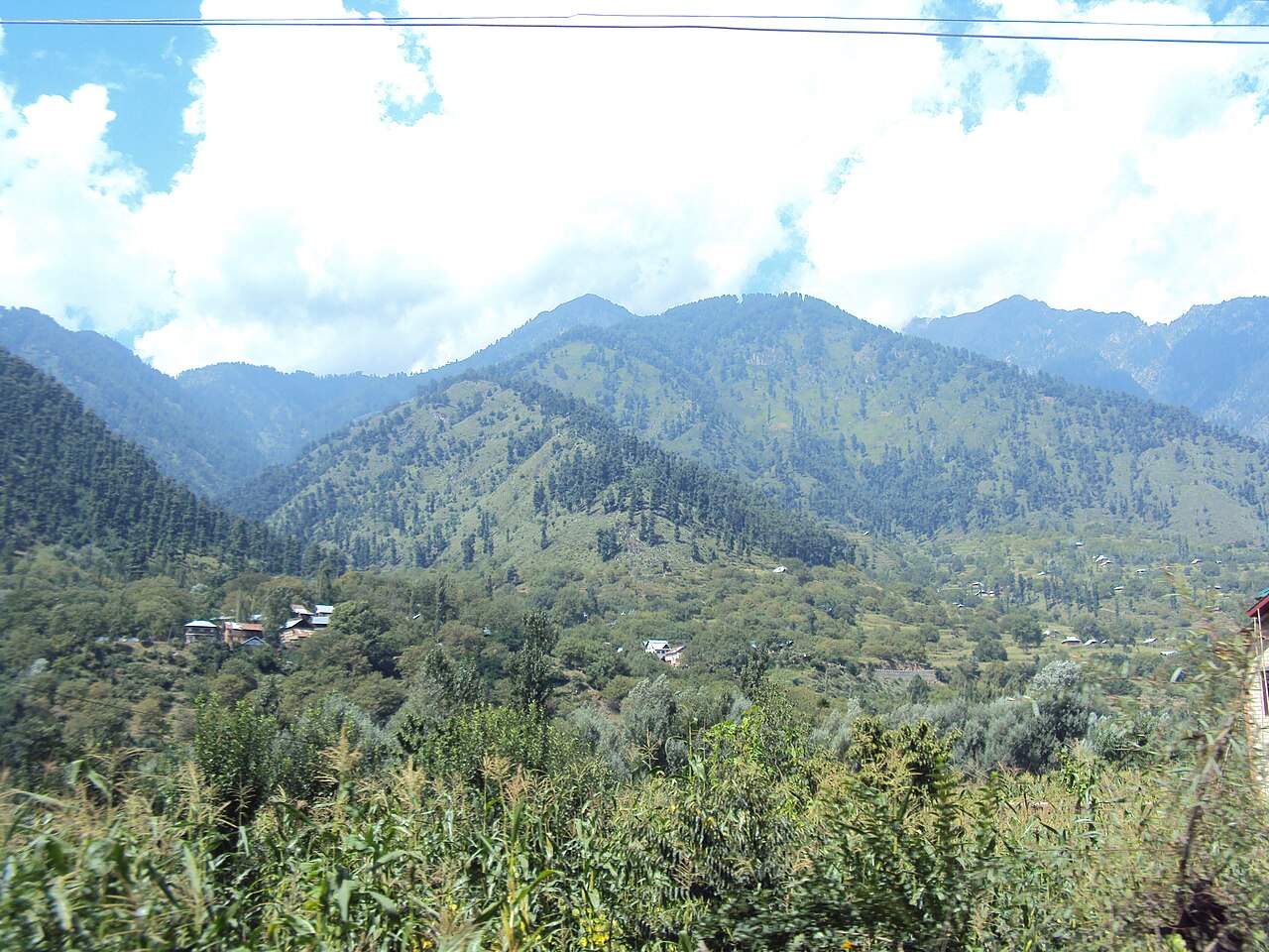 Wide shot of the Lidder River flowing near the road.