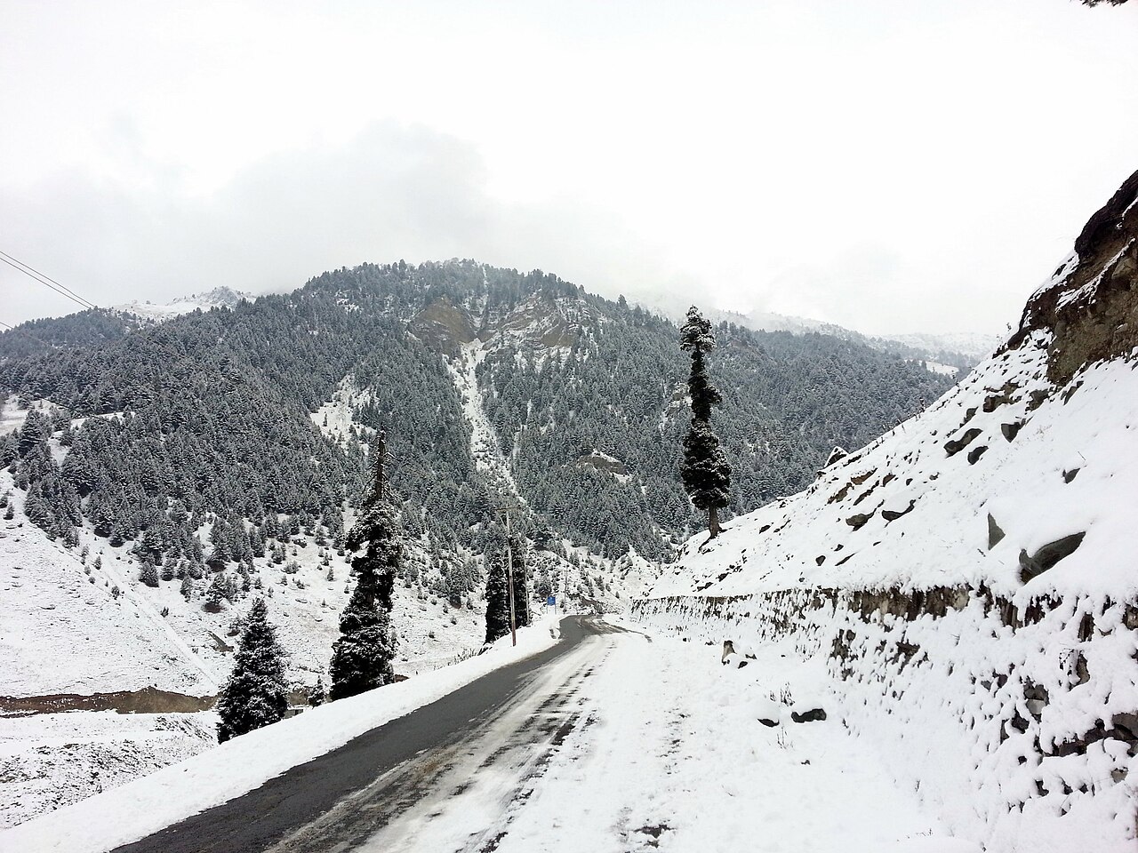 A road covered in light snow during winter