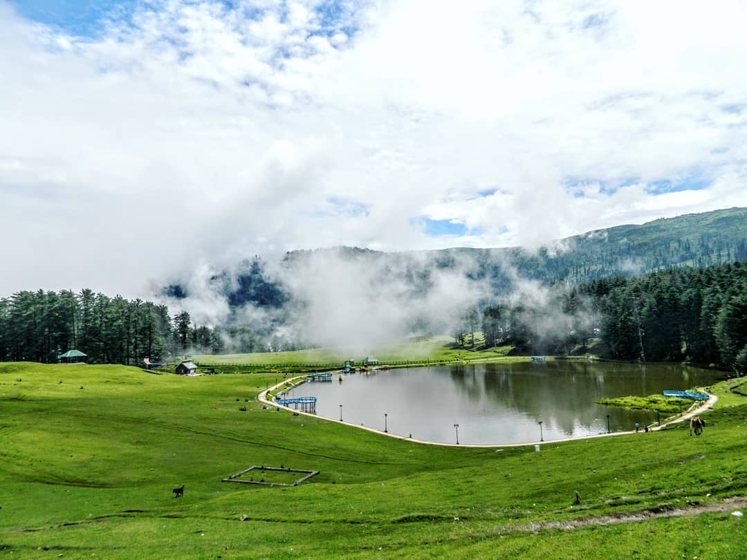 Winding mountain road through pine trees leading to Sanasar