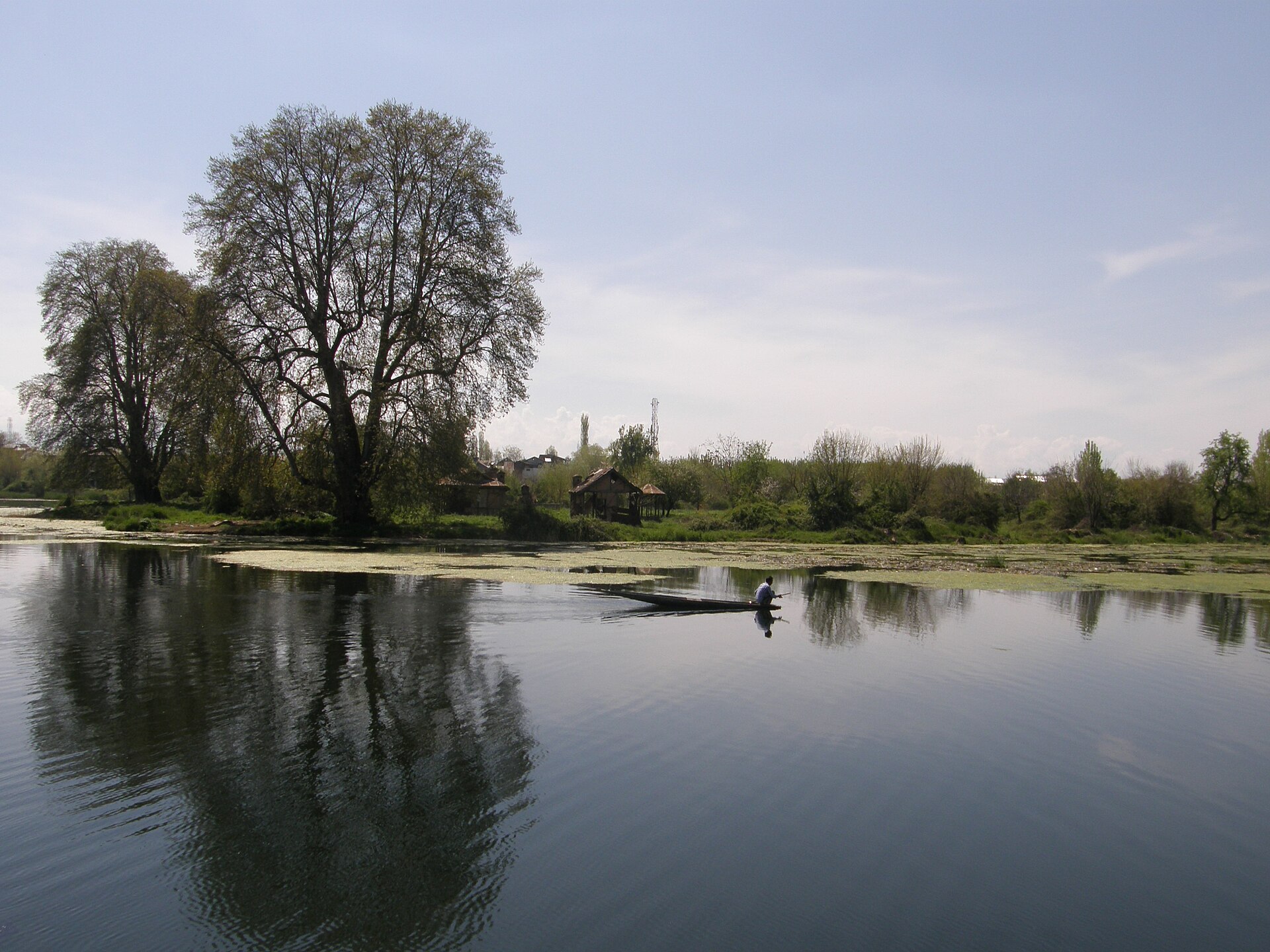 Empty shikara floating on calm Nigeen Lake