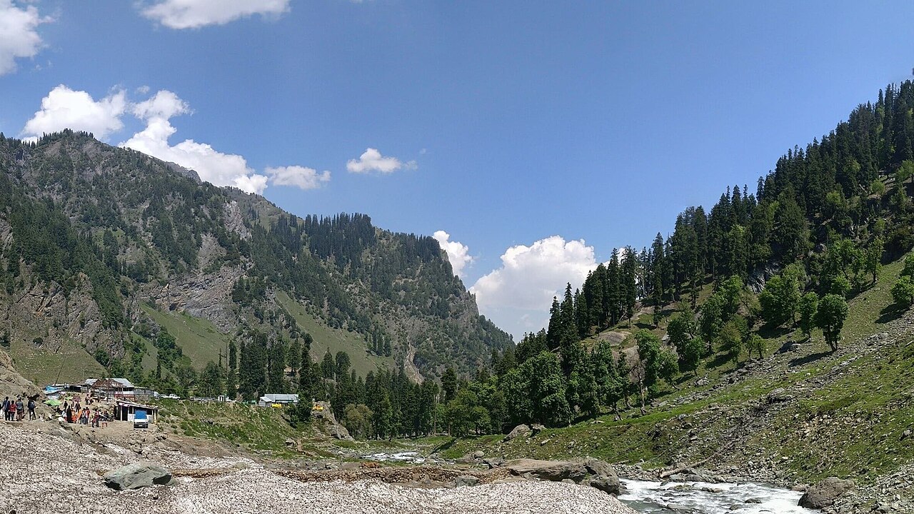 High-altitude alpine lake surrounded by steep, barren mountain peaks
