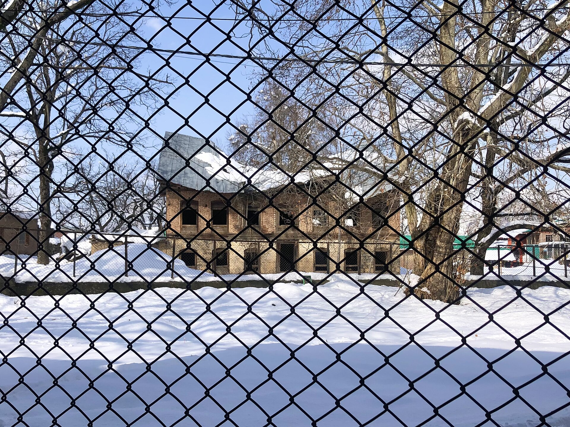A traditional Kashmiri house with a snow-covered roof.