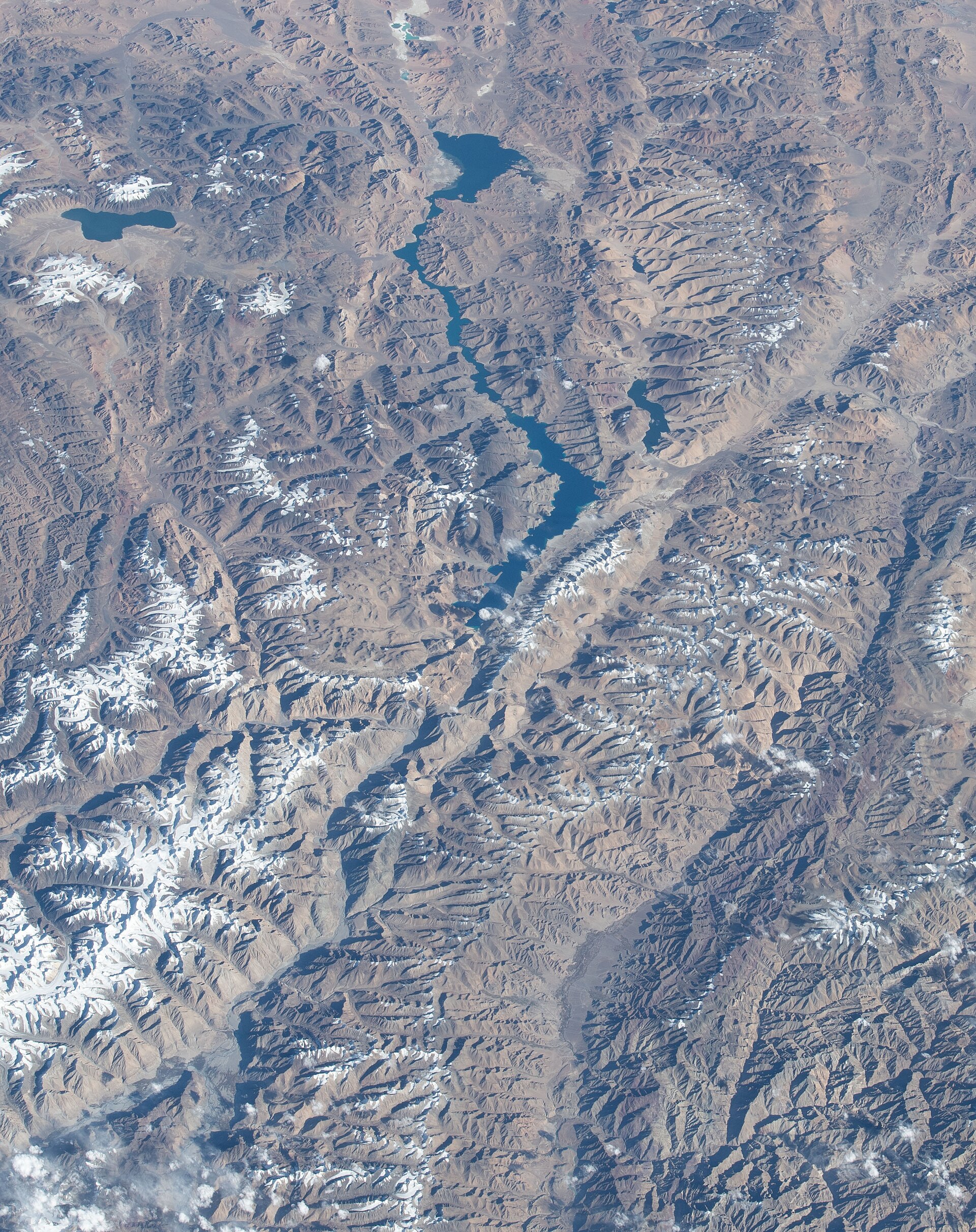 Deep blue water of Pangong Lake framed by brown mountains