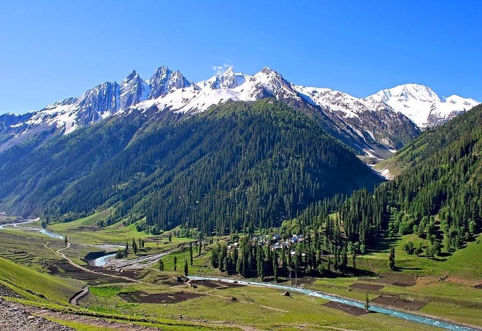 Base camp tents set up in a wide valley