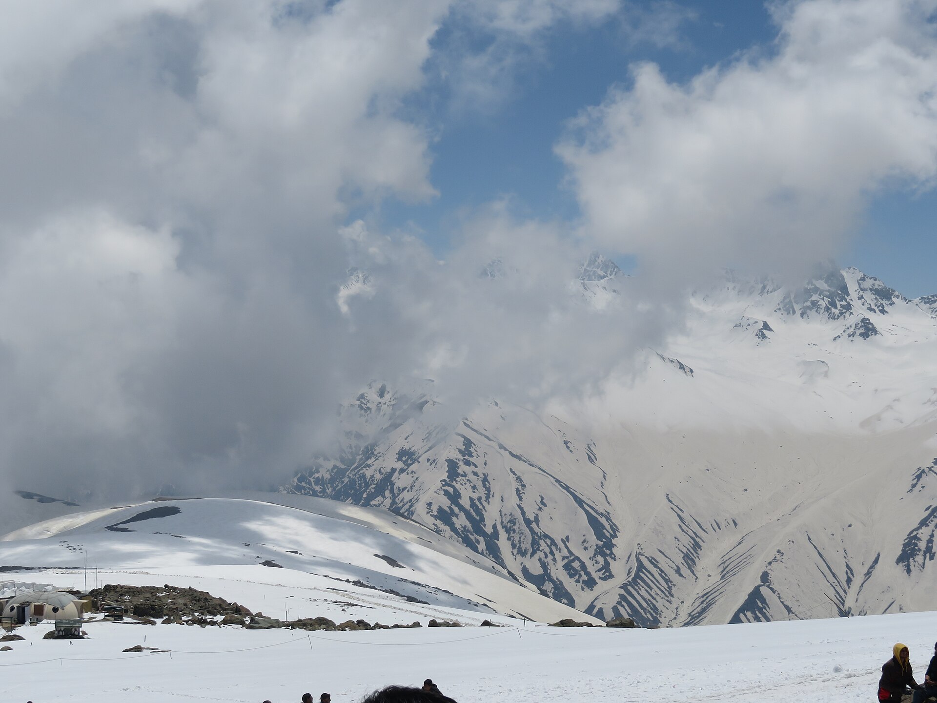The Gulmarg gondola rising above snowy peaks.