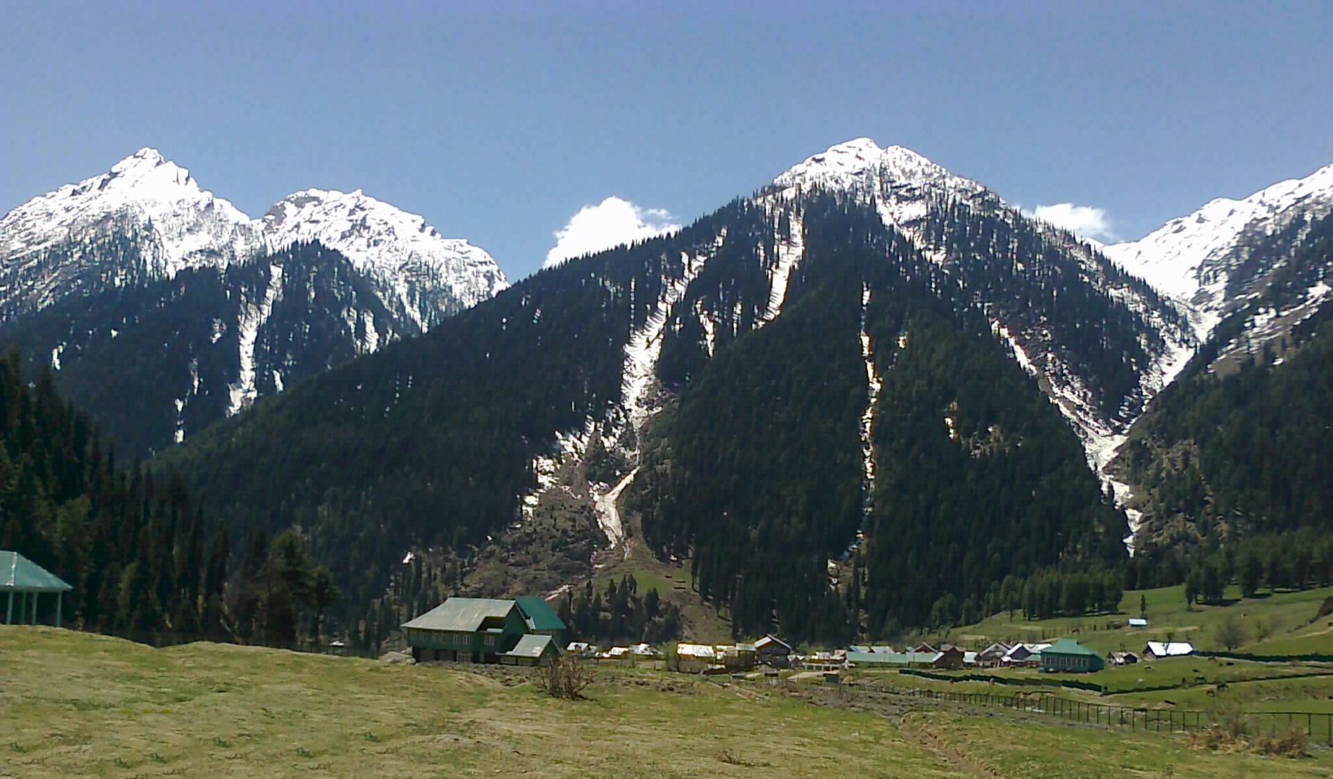 Scenic mountain background behind tour planning workspace in Srinagar