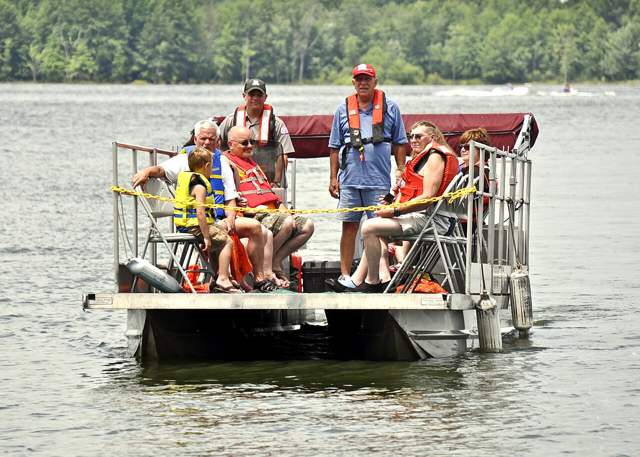A stack of life jackets on a wooden boat