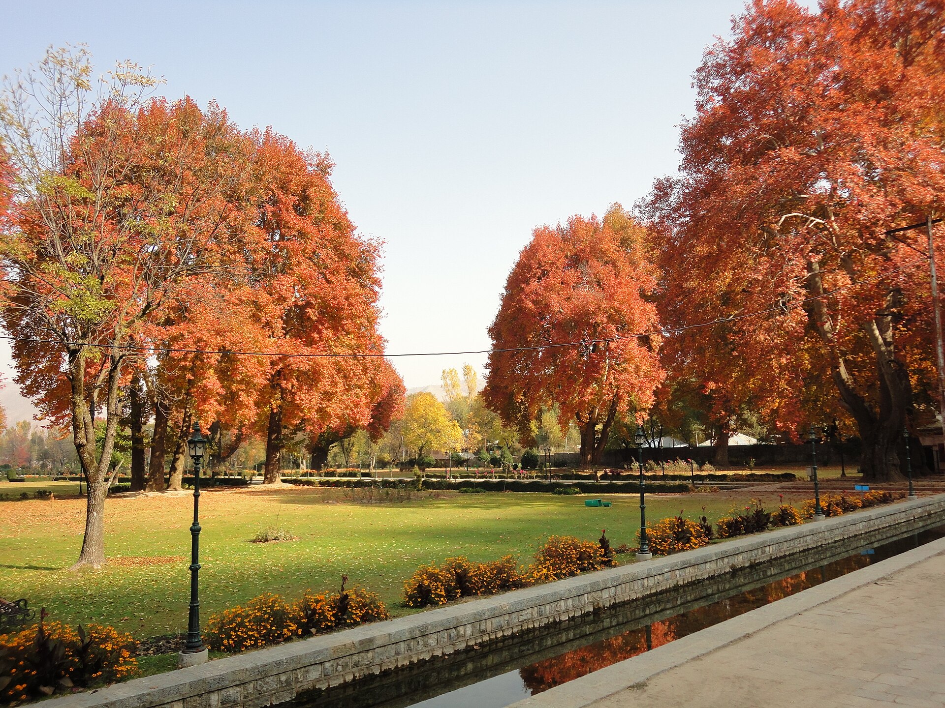 The octagonal pool at Verinag surrounded by golden chinar trees in autumn
