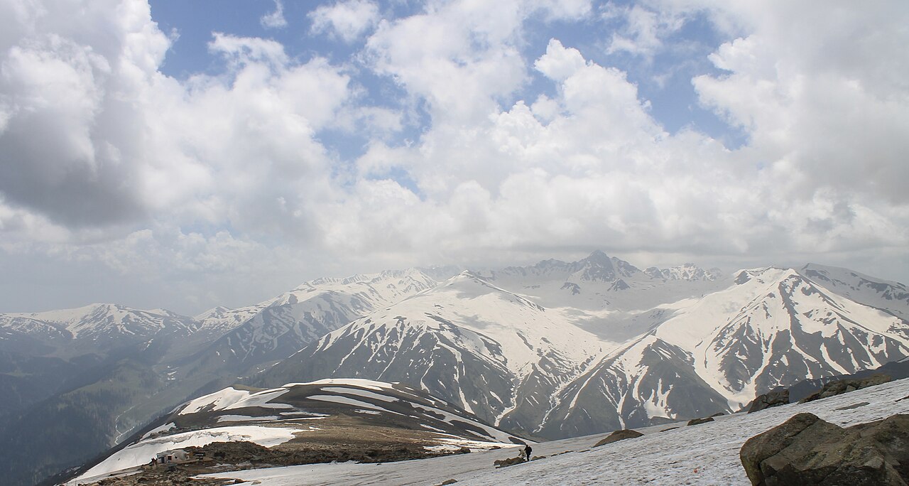 Winding road leading towards the mountains in Kashmir