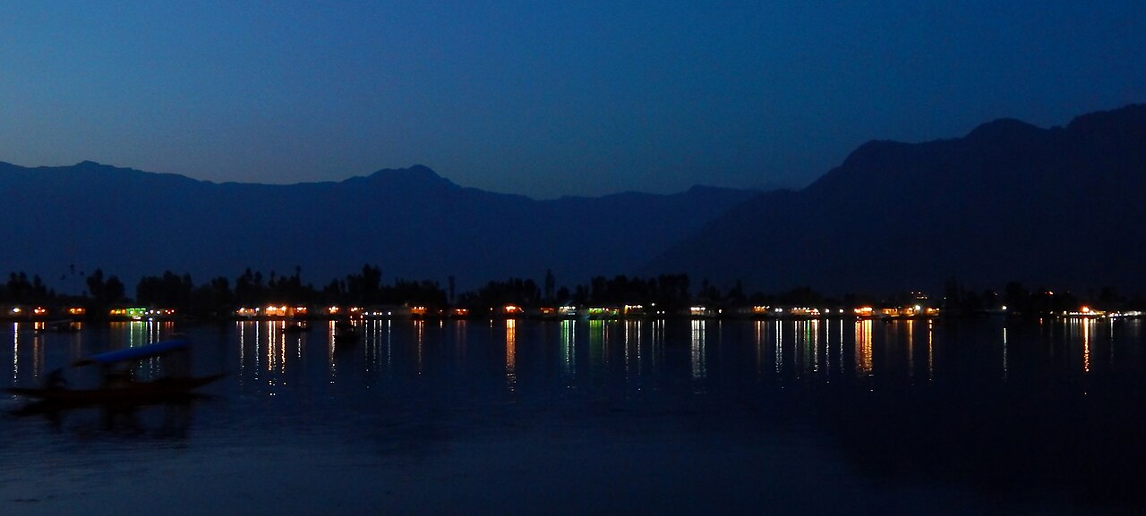 Houseboats lit up at night on Dal Lake
